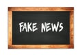 FAKE  NEWS text written on wooden frame school blackboard Royalty Free Stock Photo