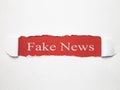 Fake News words on torn paper. Royalty Free Stock Photo