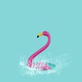 fake pink flamingo in a puddle of water
