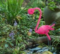 Fake pink flamingo isolated in a pond