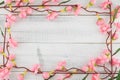 Fake pink flower branches on white background