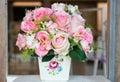 Fake pink rose bouquet in white vase