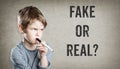 Fake or real, Boy on grunge background Royalty Free Stock Photo