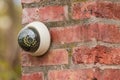 Fake security camera on the wall outside. security camera on a brick pillar in the yard Royalty Free Stock Photo