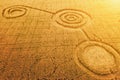 Fake UFO circles on grain crop yellow field, aerial view from drone. Round geometry shape symbols as alien signs Royalty Free Stock Photo