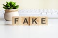 fake word made with wooden blocks, concept Royalty Free Stock Photo