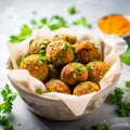 Falafel balls with parsley and spices in a bowl.