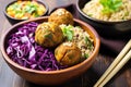 a falafel bowl with brown rice and purple cabbage served in a bamboo bowl