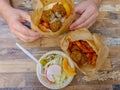 Falafel in Pita and salad, man`s hands.