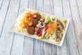 Falafel plate menu with yogurt, cherry tomatoes, white rice and basmati mixed with purple cabbage, red and green peppers, onion