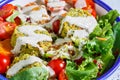Falafel salad with baked vegetables, tahini dressing and tomatoes in white bowl. Israeli street food concept Royalty Free Stock Photo
