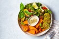 Falafel salad bowl. Vegan lunch plate - baked chickpea patties with baked sweet potatoes and vegetable salad in a white plate, top Royalty Free Stock Photo