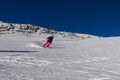 Ski slope with skier under blue sky. People drive down the snowy mountains on skis. Group of