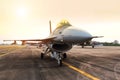 Falcon fighter jet military aircraft parked on runway on sunset