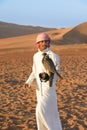 Falconer and falcon man with bird of prey in Abu Dhabi, UAE, United Arab Emirates