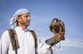 Falconer with a falcon in a desert near Dubai