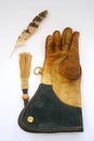 Falconry glove and feather.