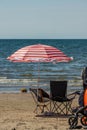 Beach chairs and red and white parasole on a beach.. Royalty Free Stock Photo