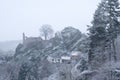 Castle ruins and rocks above houses on a hill Royalty Free Stock Photo