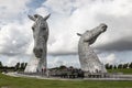 Large statue of The Kelpies, horses heads in Falkirk, Scotland created by Andy Scott with tourist around