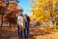 Fall activities. Senior couple walking in autumn park. Middle-aged man and woman hugging and chilling outdoors Royalty Free Stock Photo