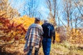 Fall activities. Senior couple walking in autumn park. Middle-aged man and woman hugging and chilling outdoors Royalty Free Stock Photo