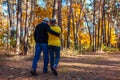 Fall activities. Senior couple walking in autumn park. Middle-aged man and woman hugging and chilling outdoors Royalty Free Stock Photo