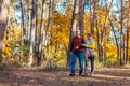 Fall activities. Senior family couple walking in autumn park. Man and woman chilling outdoors enjoying nature