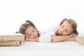 Fall asleep on lesson. Girls fall asleep while work school project white background. Schoolgirls tired of studying. Kids Royalty Free Stock Photo