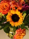 Fall autumn color flower arrangement: sunflowers, peach roses, purple puffy flowers