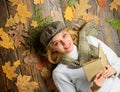 Fall and autumn season. Woman lady in checkered hat and scarf read book. She likes detective genre. Girl in vintage