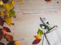 Fall or autumn themed place setting with a knife, spoon and fork, napkin on a plate on an arrangement of colorful leaves, copy Royalty Free Stock Photo