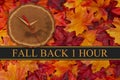 Fall back 1 hour time change with wood clock Royalty Free Stock Photo