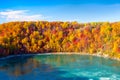 Fall background. Landscape during day light. Autumn trees on the river bank. Mountains and forest. Vivid colours in the forest. Royalty Free Stock Photo