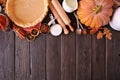 Fall baking top border with pumpkin pie ingredients over a dark rustic wood background Royalty Free Stock Photo