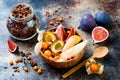 Fall breakfast bowl with chocolate granola, coconut yogurt and autumn seasonal fruits and berries. Healthy vegetarian breakfast