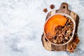 Fall breakfast bowl with cinnamon granola, coconut yogurt, chia seeds and pumpkin puree. Healthy vegan, vegetarian autumn smoothie