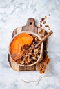Fall breakfast bowl with cinnamon granola, coconut yogurt, chia seeds and pumpkin puree. Healthy vegan, vegetarian autumn smoothie