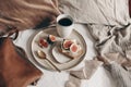 Fall breakfast still life. Bread sandwich with cheese and skiced fig, leather bag and cup of coffee on white linen