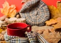 Fall bucket list concept. Mug cozy aromatic tea beverage in scarf and treats. Enjoy cozy autumnal atmosphere. Mug of tea