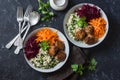 Fall buddha bowl. Bulgur, spinach, meatballs, beets, carrots - balanced healthy eating lunch. On a dark background, top view.