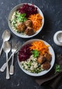 Fall buddha bowl. Bulgur, spinach, meatballs, beets, carrots - balanced healthy eating lunch. On a dark background, top view Royalty Free Stock Photo