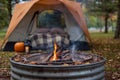 Campfire and cozy tent in fall