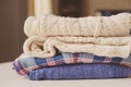 Fall casual woman fashion clothes set. Stack of plaid shirts and knitted sweaters Royalty Free Stock Photo