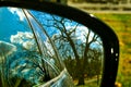 Fall colors are reflected in a rearview mirror of a car parked in an Indiana forest Royalty Free Stock Photo