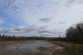 Cloudy sky and fall colors are reflected in a river in Hayward, Wisconsin