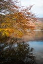 Fall colors reflected in the still waters of Morske oko lake, Slovakia Royalty Free Stock Photo