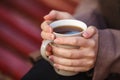 Fall concept - autumn woman drinking coffee on park bench under Royalty Free Stock Photo