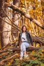 Fall concept - beautiful woman in autumn park under fall foliage Royalty Free Stock Photo