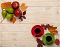 Fall concept. Cups of coffee, apples, pears and autumn leaves on